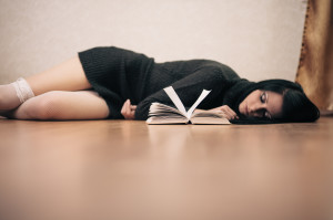 Picture of woman lying on floor looking reading