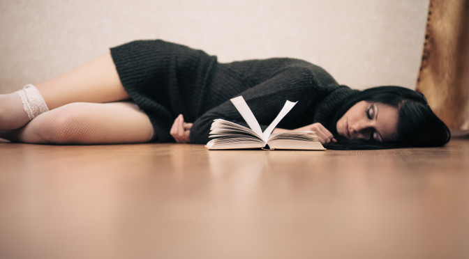 Picture of woman lying on floor looking reading