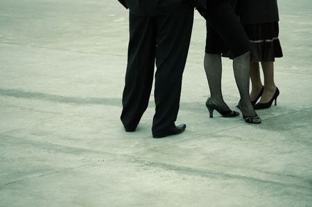 Image of two women and a man, focusing on only legs