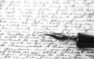 B/W image of calligraphic pen resting on handwritten note