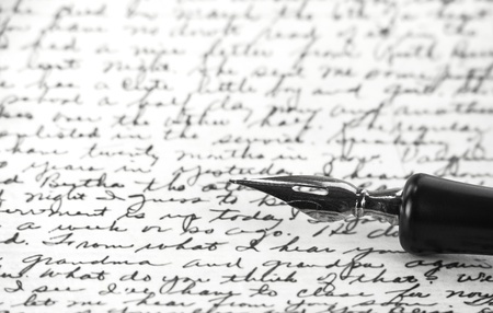 B/W image of calligraphic pen resting on handwritten note; Steve Collender ©123RF.com