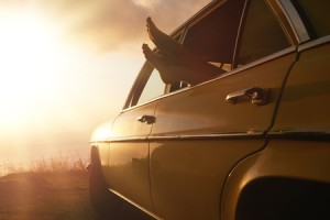 Picture of feet sticking out of car window, parked to watch sunset